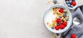 Yogurt with berries and granola in bowl