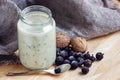 Yogurt with berries and nuts in a glass jar for healthy morning meal, selective focus Royalty Free Stock Photo