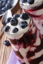 Yogurt with blueberries in a glass jar on wooden table Royalty Free Stock Photo