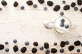 Yogurt with blueberries, teaspoon, blackberries and blueberries on the edges