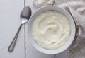 Yogurt bowl with natual creamy white Greek yoghurt on white rustic table close up