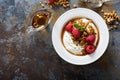 Yogurt bowl with raspberry and maple syrup