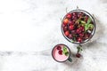 Yogurt with cherry, mint and and fresg berries on a light concrete background. Summer healthy dessert with berries