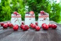 Yogurt with Cherry and strawberries, square. Berries of blueberries and strawberries are scattered on the table.