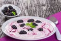 Yogurt with colored stains and mulberry on plate Royalty Free Stock Photo