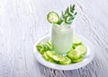 Yogurt and cucumber smoothie with dill on wooden background