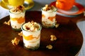 Yogurt dessert with apricot and candied nuts on cutting board