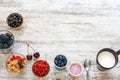 Yogurt, fresh berries, cornflakes and cup of milk on a wooden table. Royalty Free Stock Photo
