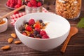 Yogurt with fresh berries, muesli oatmeal granola on the wooden table. Healthy breakfast concept Royalty Free Stock Photo