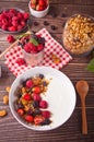 Yogurt with fresh berries, muesli oatmeal granola on the wooden table. Healthy breakfast concept Royalty Free Stock Photo