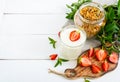 Yogurt, fresh ripe strawberry, granola - dietary dish on a white wooden table. Royalty Free Stock Photo