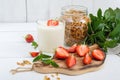 Yogurt, fresh ripe strawberry, granola - dietary dish on a white wooden table. Royalty Free Stock Photo