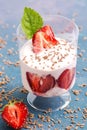 Yogurt with fresh strawberries in a glass on a blue background. Selective focus. Summer dessert with strawberries. Royalty Free Stock Photo