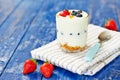 Yogurt glass with berries and musli on table