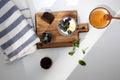 Yogurt in a glass jar with chocolate, blueberries and honey on a wooden board on a white background with mint leaves Royalty Free Stock Photo