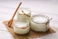 Yogurt in glass jars on wooden background Royalty Free Stock Photo