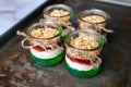 Yogurt with granola, decorated for Christmas with red and green jelly and jello. Christmas glass jar dessert