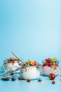 Yogurt with granola, fresh berries and nuts in a jar on a blue background. Healthy breakfast and dessert milk concept Royalty Free Stock Photo