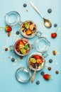 Yogurt with granola, fresh berries and nuts in a jar on a blue banner background. Healthy breakfast and dessert milk Royalty Free Stock Photo