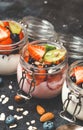 Yogurt with granola, fresh berries and nuts in a jar on a dark background. Healthy breakfast and dessert concept Royalty Free Stock Photo
