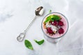 Yogurt granola parfait with frozen raspberries, coconut flakes and chia seeds, layered dessert or breakfast. Selective focus. Top