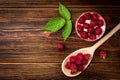 Yogurt with granola, raspberry and raspberry jam on dark wooden background Royalty Free Stock Photo