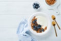 Yogurt. Greek Yogurt with granola and fresh blueberries in white bowl over old white wood background. Morning breakfast concept. Royalty Free Stock Photo