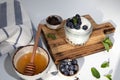 Yogurt in a jar with granola, chocolate, blueberries and honey on a wooden board on a white background with mint leaves Royalty Free Stock Photo