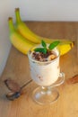 Yogurt Jelly Dessert with banana, strawberry, cocoa, fresh mint in a glass on wooden cut board.Healthy vegan sweet food Royalty Free Stock Photo