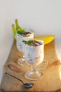 Yogurt Jelly Dessert with banana, strawberry, cocoa, fresh mint in a glass on wooden cut board.Healthy vegan sweet food Royalty Free Stock Photo