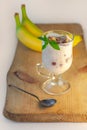 Yogurt Jelly Dessert with banana, strawberry, cocoa, fresh mint in a glass on wooden cut board.Healthy vegan sweet jello Royalty Free Stock Photo