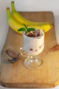 Yogurt Jelly Dessert with banana, strawberry, cocoa, fresh mint in a glass on wooden cut board.Healthy vegan sweet jello Royalty Free Stock Photo