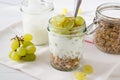 Yogurt, muesli and grapes in glass jars Royalty Free Stock Photo