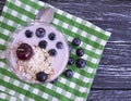 Yogurt oatmeal cherry, dessert homemade blueberry glass on a black wooden background