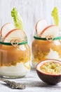 Yogurt with passion fruit glass jar on a rustic background.