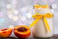 Yogurt with peaches, bokeh background, closeup Royalty Free Stock Photo