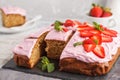 Yogurt pound cake for breakfast with pink glaze and fresh strawberries. Light background, summer dessert. Breakfast concept.