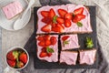 Yogurt pound cake for breakfast with pink glaze and fresh strawberries. Light background, summer dessert. Top view, copy space.