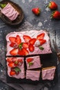 Yogurt pound cake for breakfast with pink glaze and fresh strawberries. Dark background, summer berry dessert. Top view, copy spa