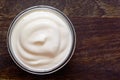 Yogurt, sour cream bowl on wood background. Healthy dairy food, white sauce portion