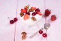 Yogurt with strawberries and cherries and walnuts in a glass bowl. Royalty Free Stock Photo