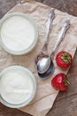 Yogurt with strawberries in a glass and a bucket with fresh stra