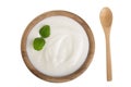 Yogurt in a wooden bowl with mint leaf isolated on white background top view