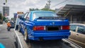 Blue BMW M3 E30 coupe on towing truck