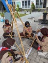 Yogyakarta, Indonesia - January, 21, 2022 : a group of Girls Scout practice making towers using ropes and sticks at school