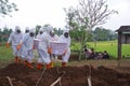 Yogyakarta, Indonesia - July 11, 2021 : Some people in hazmat suits carryng coffin of covid19 victim at daylight