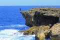 A tourist endangers his life by taking a selfie at the edge of a cliff