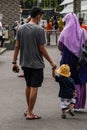 Yogyakarta, Indonesia - March 03, 2022: A father is walking with his toddler in the Suraloka Zoo area, Yogyakarta