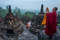 Yogyakarta, Indonesia - March 17, 2018: Monk makes photos at Borobudur temple sunrise in Yogyakarta