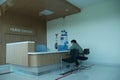 Yogyakarta, Indonesia - May 9, 2021 : Asian Nurse and patient conversing at reception desk in hospital